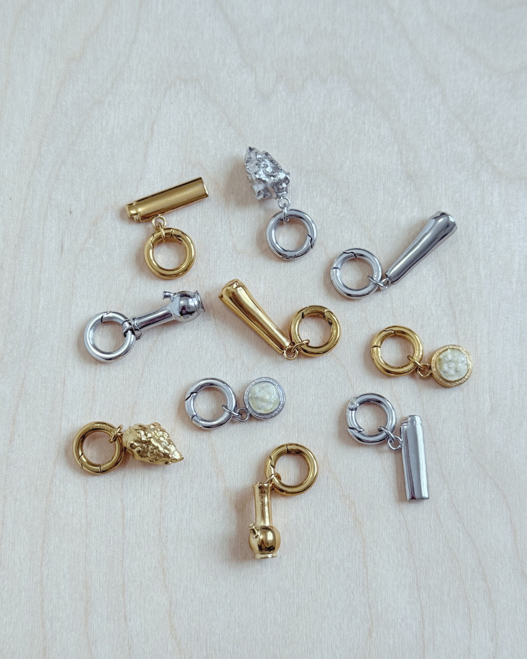 Unique cannabis charms, featuring a bong charm, roach, nug, lighter and dab jars